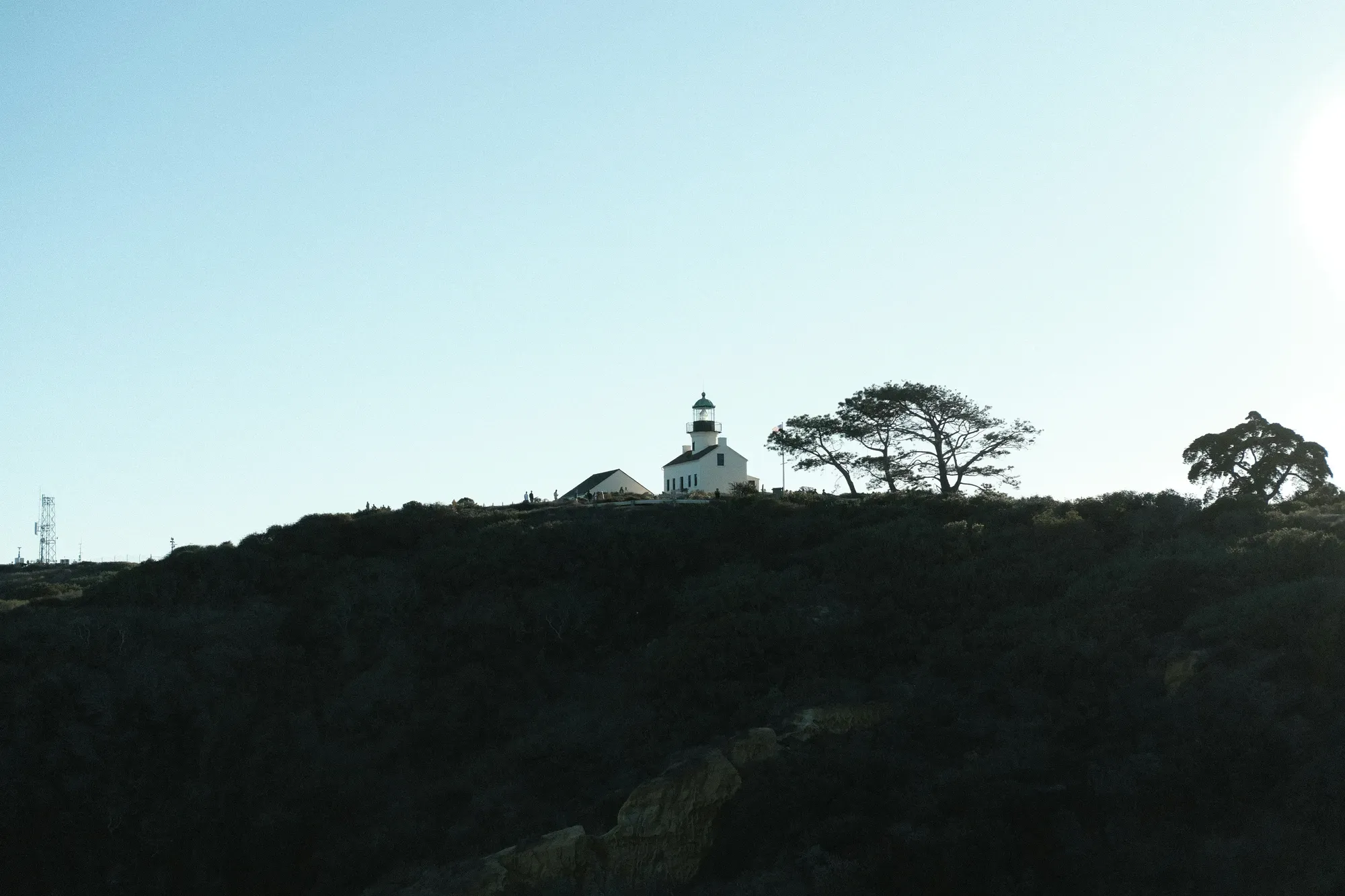 The Old Point Loma Lighthouse silhouetted on the hilltop at Cabrillo National Monument at dusk